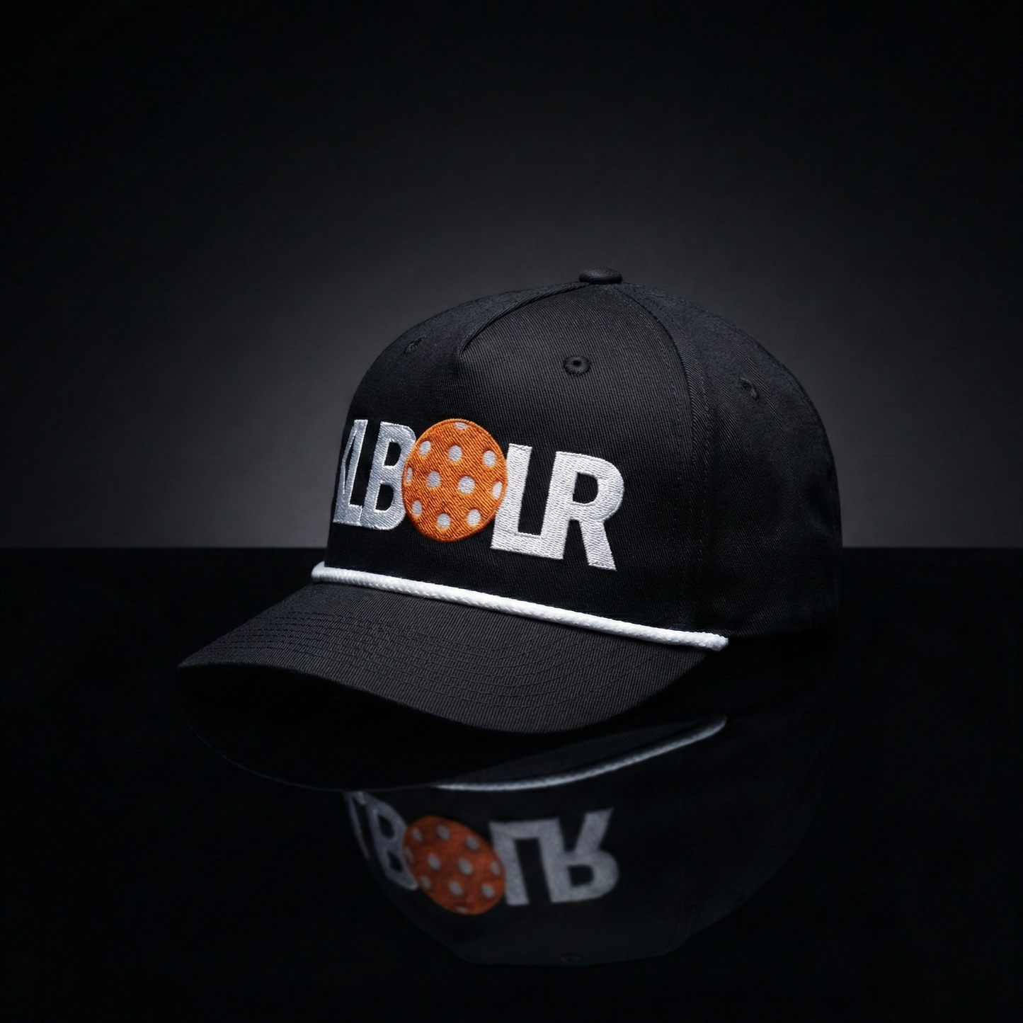 Black cap with 'LBOR' logo on a reflective black surface